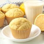 A vegan lemon muffin sitting on a small white plate.