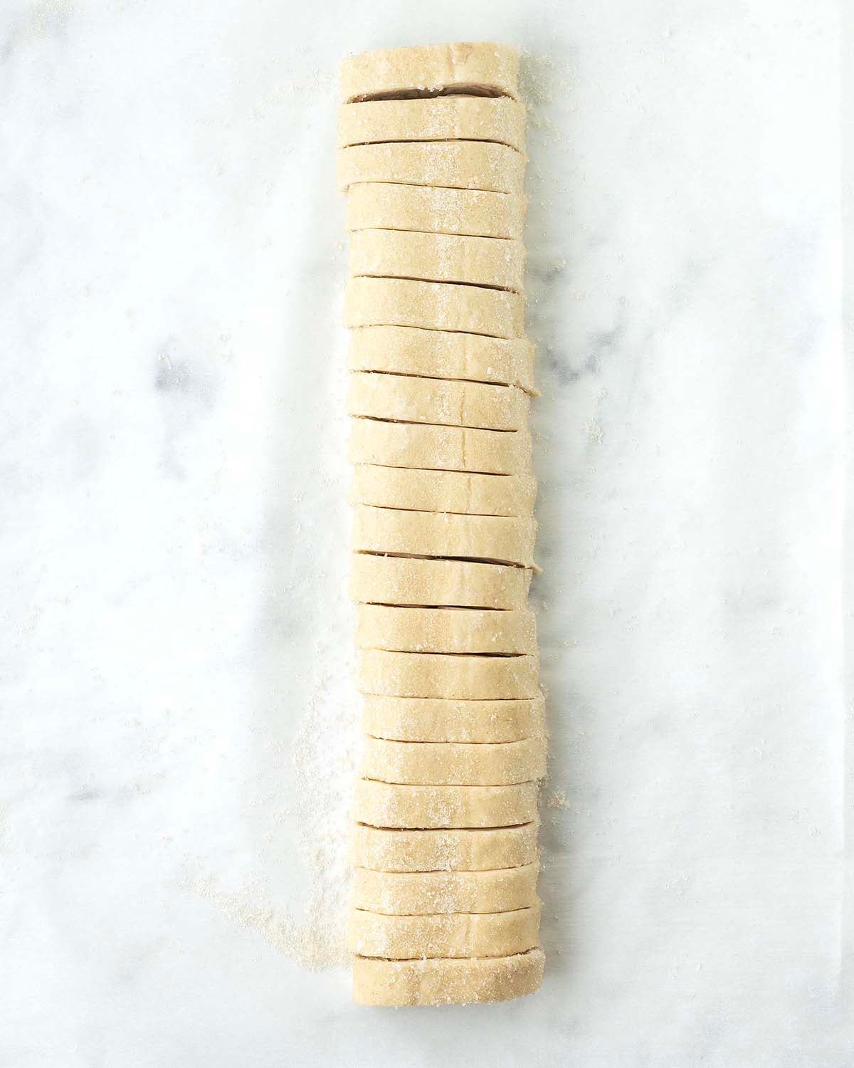 A log of sliced puff pastry to make palmiers.