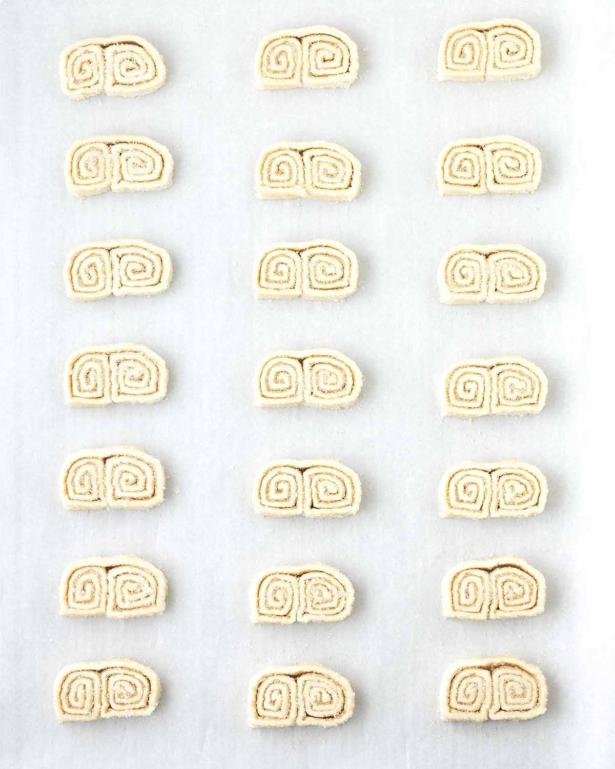 Unbaked vegan palmiers on a parchment lined baking sheet.