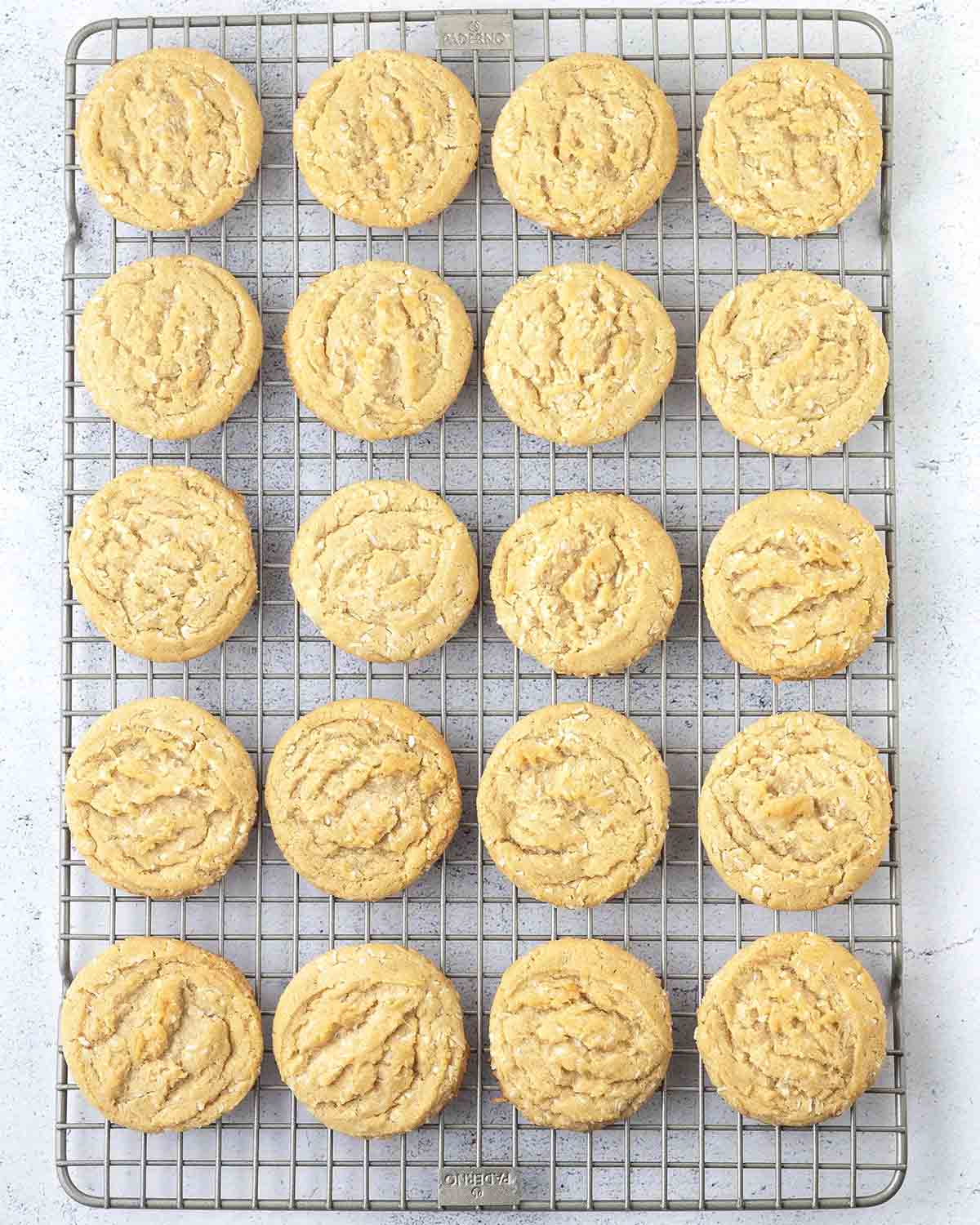 Vegan coconut cookies on a metal cooling rack.