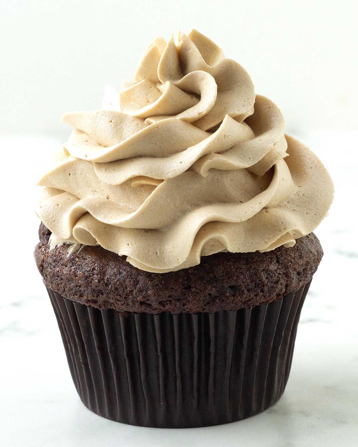 A chocolate cupcake topped with dairy-free coffee frosting.