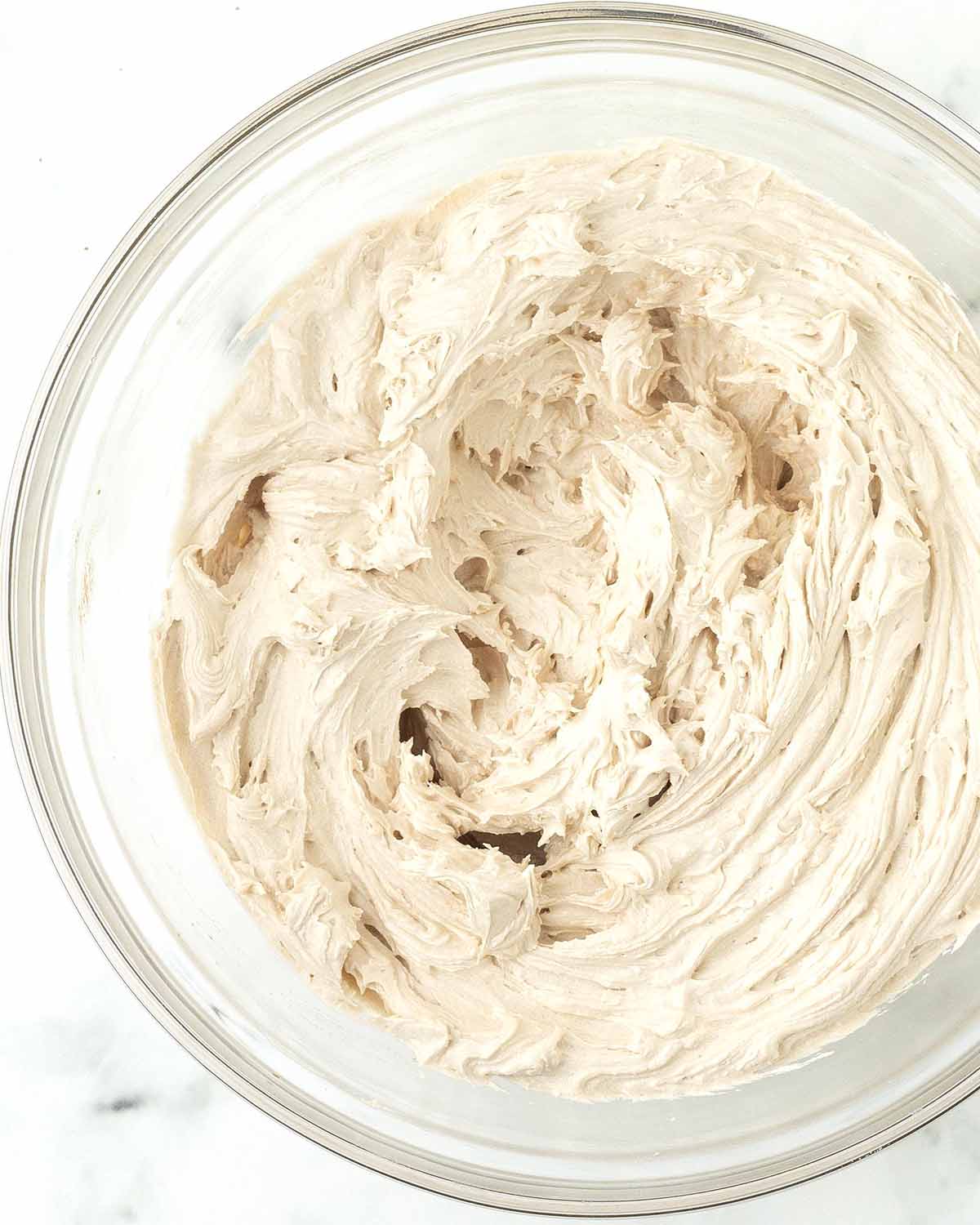 Coffee frosting in a glass bowl.