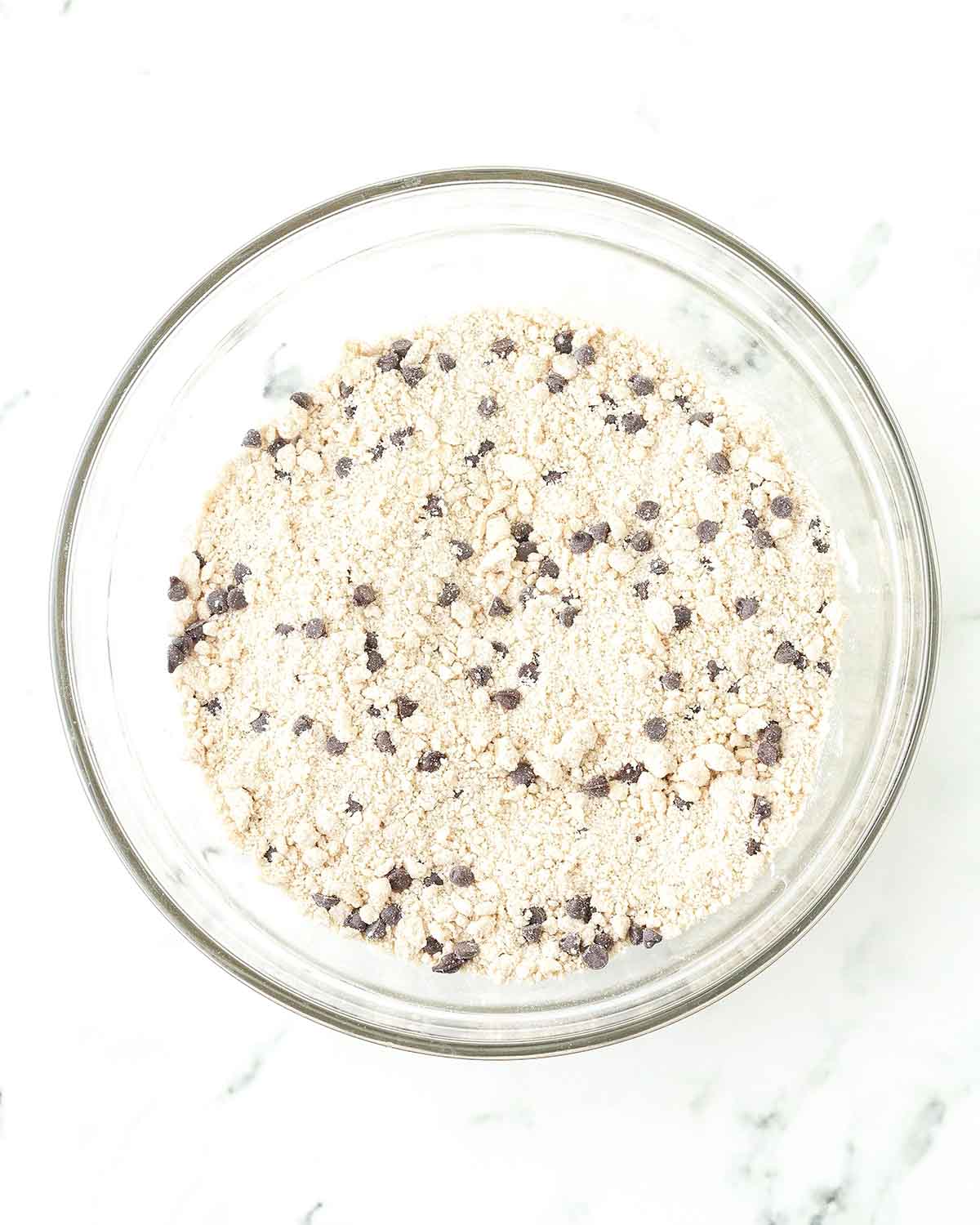 The dry ingredients for chocolate chip scones in a glass bowl.