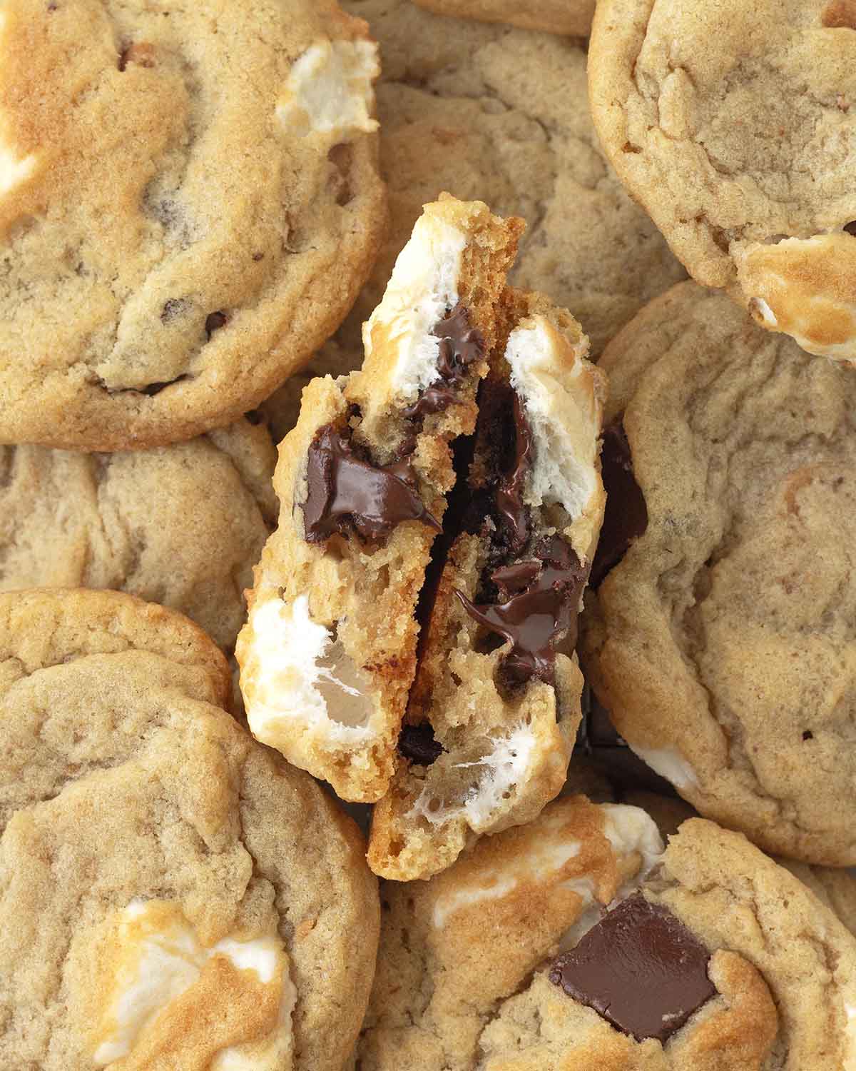 An overhead image of s'mores cookies, one cookie is split in half to show the gooey inside.