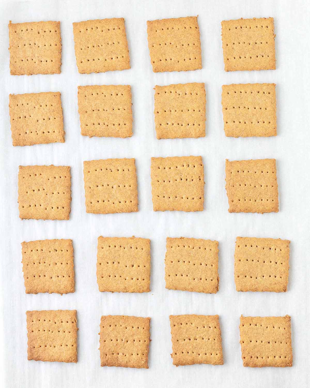 A cookie sheet full of baked graham crackers.