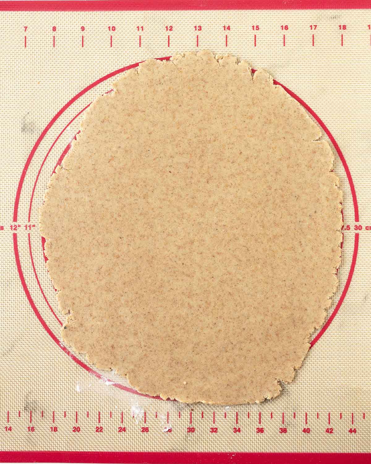 Rolled cookie dough on a pastry mat.