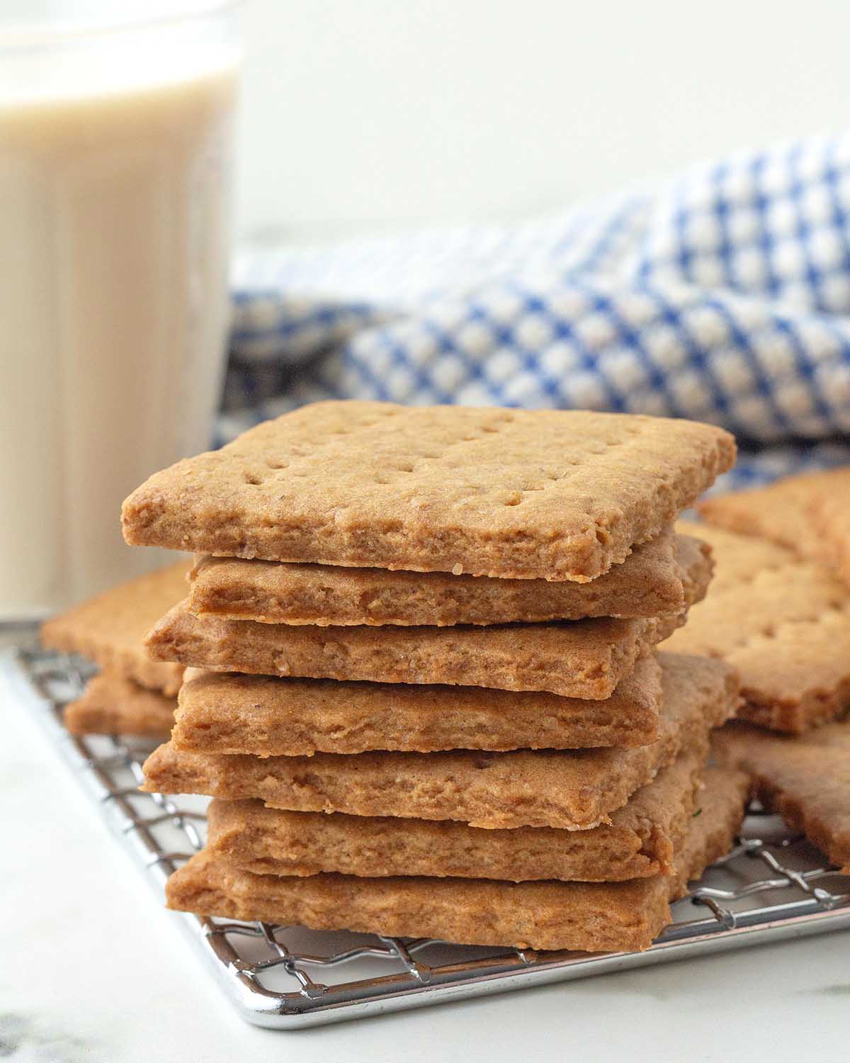 A stack of vegan graham crackers sitting on the corner of a metal rack.