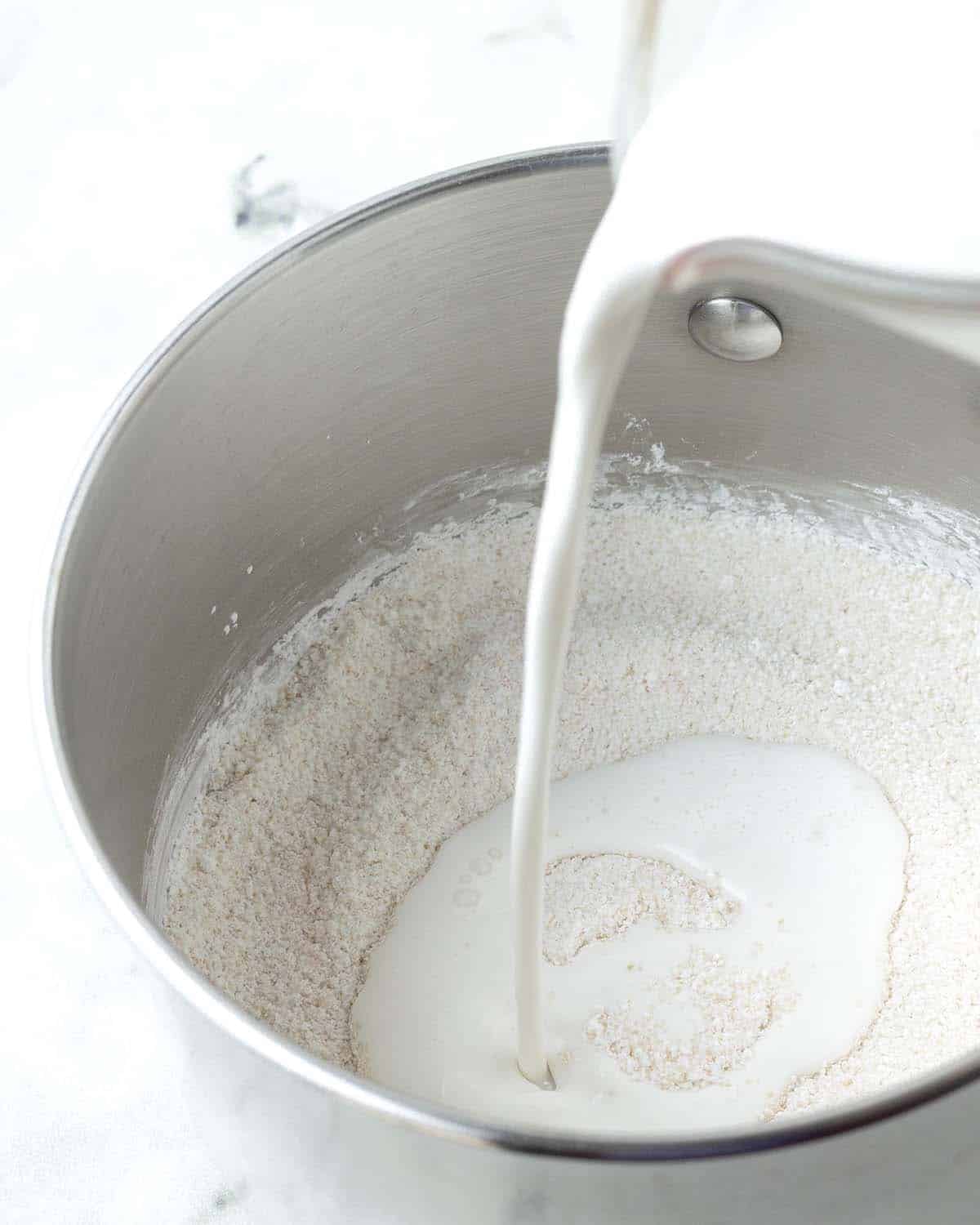 Milk being poured into a pot.