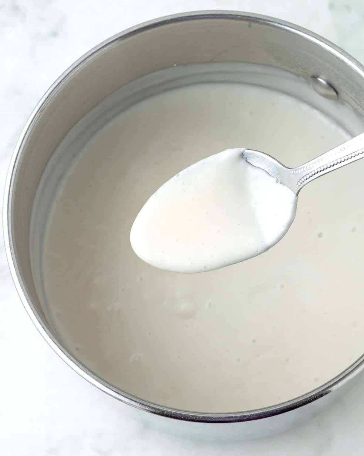 Homemade vegan custard on a spoon.