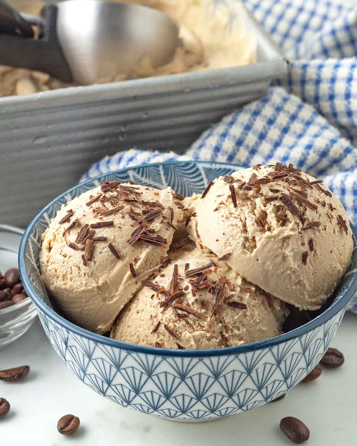 A close up image of homemade vegan coffee ice cream with chocolate shavings in a bowl.